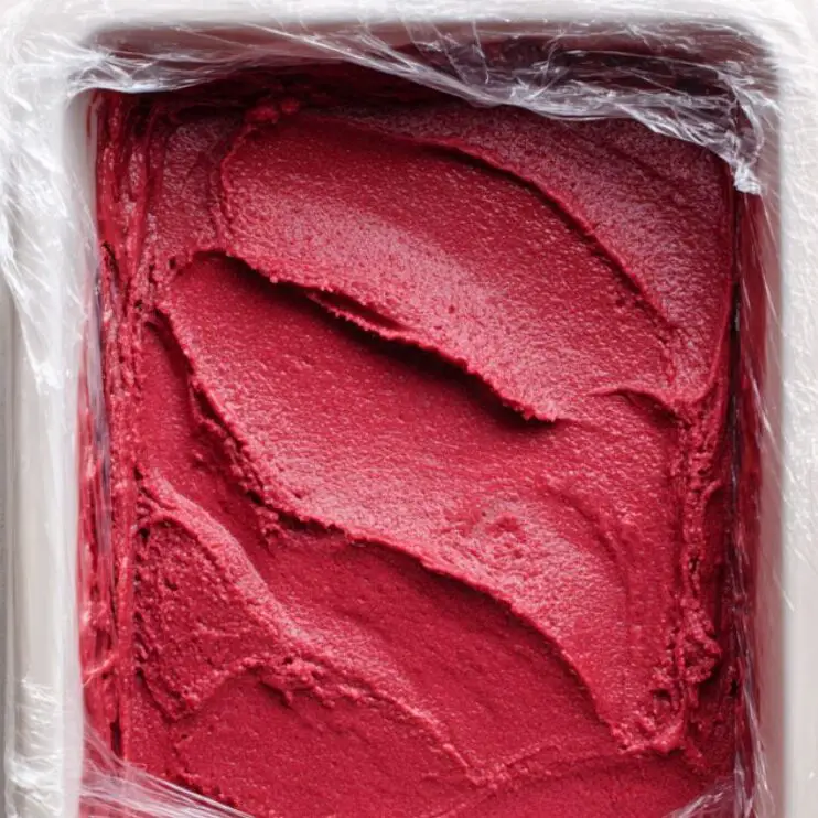 Red velvet ice cream mixture in a freezer container before setting.
