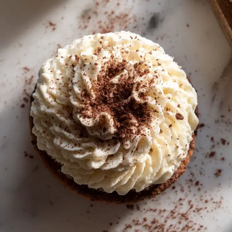 Assembling tiramisu cookies with mascarpone filling and cocoa dusting

