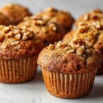 Homemade vegan banana nut muffins recipe on a white kitchen counter, photographed from above with a rustic homemade look.