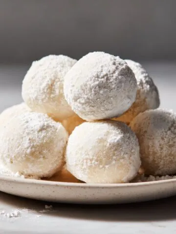 Homemade milk mochi recipe balls dusted with cornstarch on a white marble counter, captured from above in natural light for a real homemade look.